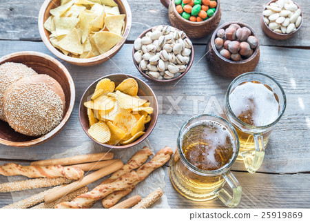 Two glasses of beer with appetizers 25919869