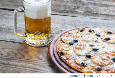 Cooked pizza with a glass of beer Cooked pizza with a glass of beer 25920086