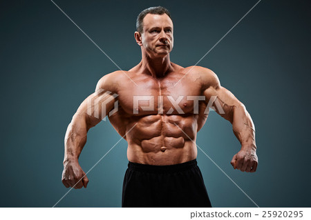 torso of attractive male body builder on gray torso of attractive male body builder on gray 25920295