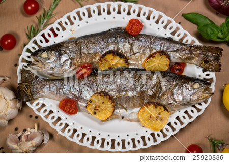 delicious trout fish baked with lemon, tomatoes 25920886