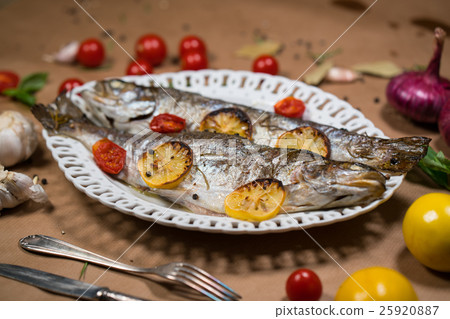 delicious trout fish baked with lemon, tomatoes 25920887