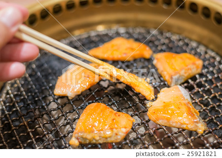 Salmon fish steak cooking over charcoal grill. Salmon fish steak cooking over charcoal grill. 25921821