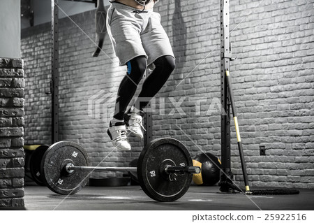 Jumping above barbell Jumping above barbell 25922516