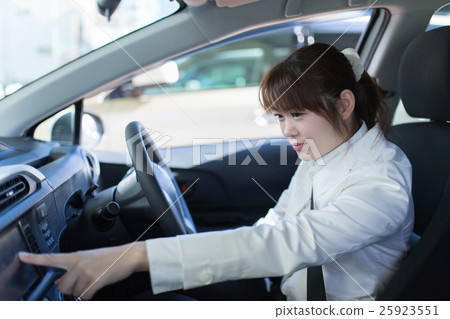 A woman riding a car 25923551