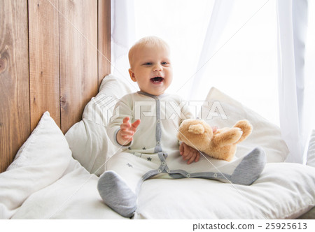 Cheerful toddler with teddy bear Cheerful toddler with teddy bear 25925613