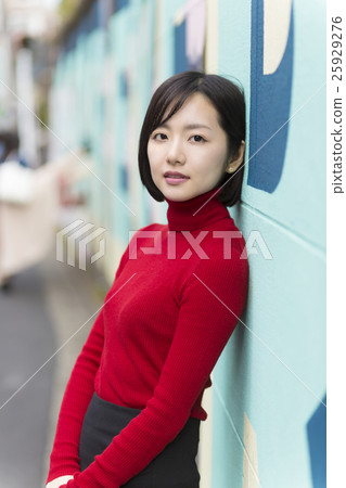 Portrait female outdoors standing wall camera looking backwards Harajuku black hair red sweater autumn Portrait female outdoors standing wall camera looking backwards Harajuku black hair red sweater autumn 25929276