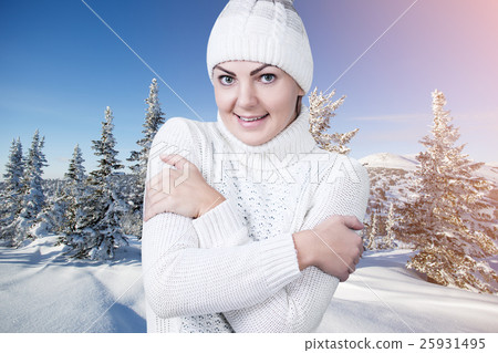 Beautiful woman in the winter snowy scenery. 25931495