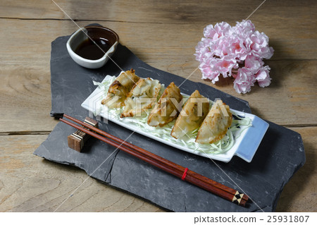 fried dumplings or gyoza on wood background fried dumplings or gyoza on wood background 25931807