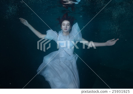 Woman in a white dress under water. 25931925
