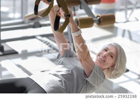 Pleasant charming woman having fitness in a gym. Pleasant charming woman having fitness in a gym. 25932198
