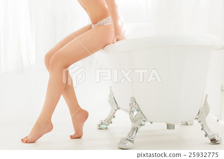 Perfect legs of woman sitting on bathroom side Perfect legs of woman sitting on bathroom side 25932775