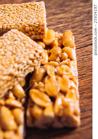 Kozinaki of sesame and peanut on a wooden Kozinaki of sesame and peanut on a wooden 25934197