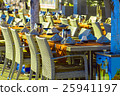 Restaurant tables and chairs on street 25941197
