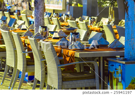 Restaurant tables and chairs on street 25941197
