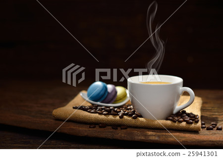 Coffee cup and coffee beans and pastries on wood Coffee cup and coffee beans and pastries on wood 25941301