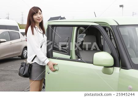 A young woman riding a car A young woman riding a car 25945244