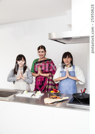 Young women learning Indian cuisine greetings (Namaste) 25950628