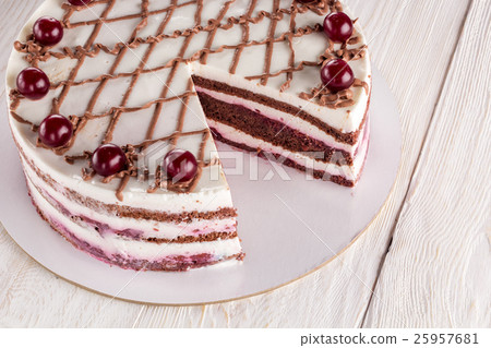 Chocolate cake with mousse, decorated cherries 25957681