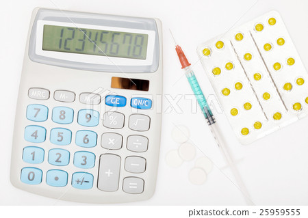 Calculator, syringe and pills on grey background Calculator, syringe and pills on grey background 25959555