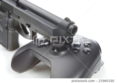 Game controller with real handgun near it 25960180