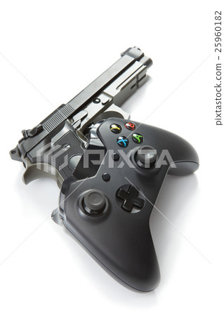 Video game controller with real handgun near it 25960182