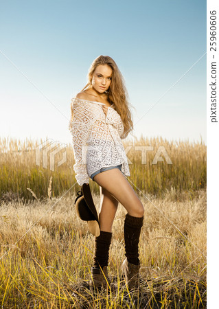Beautiful young lady model with a hat in hand Beautiful young lady model with a hat in hand 25960606