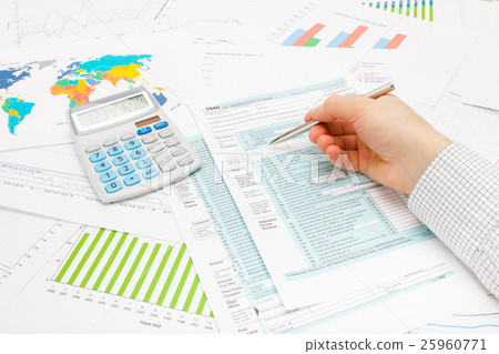 Business man pointing on 1040 US Tax Form 25960771