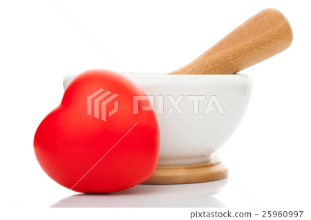 Toy heart in front of mortar and pestle Toy heart in front of mortar and pestle 25960997