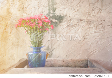 Pink flower in blue vase on wooden table 25961505