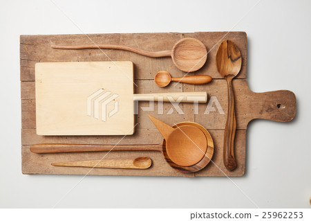Various kitchen utensil on white wooden background 25962253
