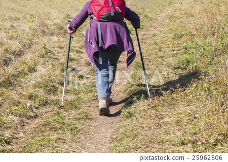 Older woman walking by hiking trail 25962806