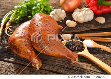 Roasted chicken thighs with ingredients on table  25963892