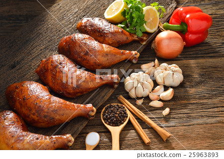 Roasted chicken thighs with ingredients on table  25963893