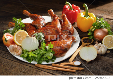 Roasted chicken thighs with ingredients on table  25963898