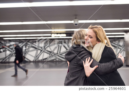 Two beautiful women standing at the underground Two beautiful women standing at the underground 25964601