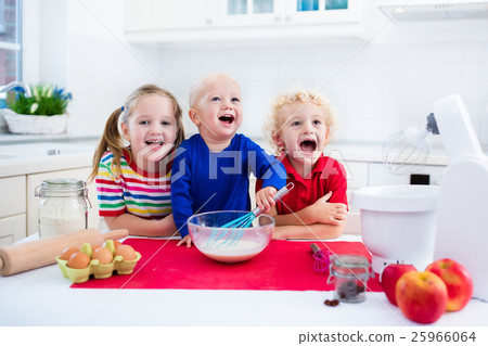 Kids baking a pie in white kitchen Kids baking a pie in white kitchen 25966064