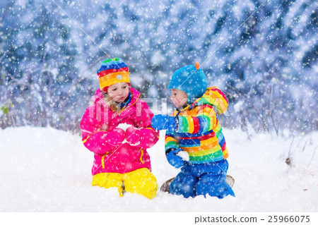 Children playing in snowy winter park 25966075