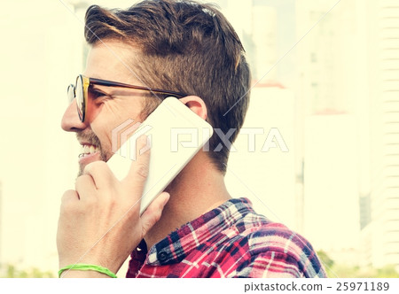 Young Man Outdoors Talking Smartphone Concept 25971189