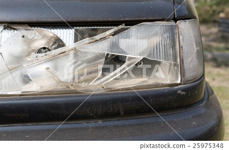 damaged car headlamp after collision 25975348