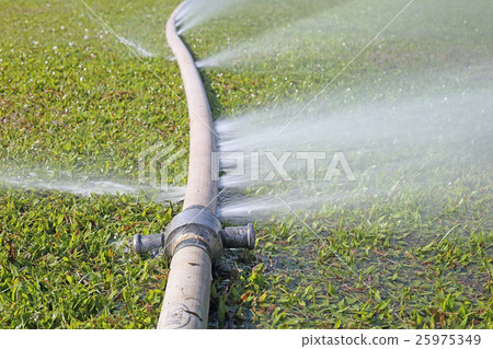 water leaking from hole in a hose 25975349