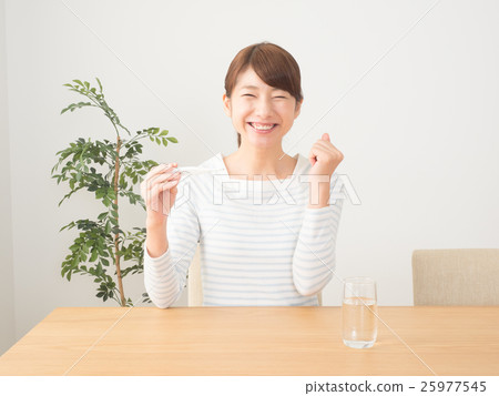 A woman rejoicing with a fall in fever 25977545