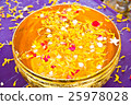 Water in bowl mixed with perfume and  flowers 25978028