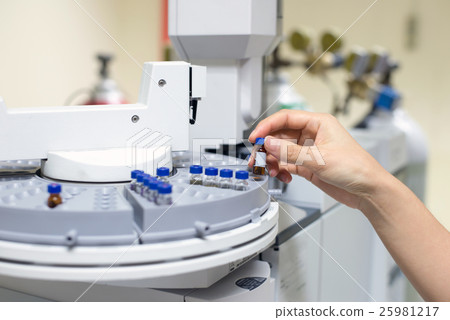 scientist holds an amber vial. scientist holds an amber vial. 25981217