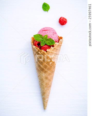 Raspberry ice cream in cone with fresh raspberry. Raspberry ice cream in cone with fresh raspberry. 25997461