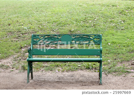 Green chair or bench on ground in public park. Green chair or bench on ground in public park. 25997669