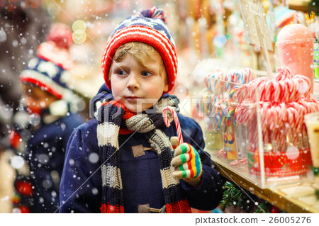 Little kid boy with candy cane stand on Christmas 26005276