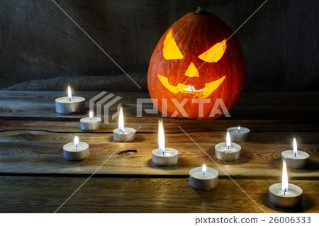 Halloween jack-o-lantern and burning candles 26006333