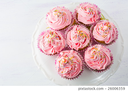 Pink cupcakes  on cake stand top view 26006359