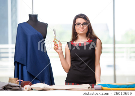 Woman tailor working on new clothing Woman tailor working on new clothing 26013699