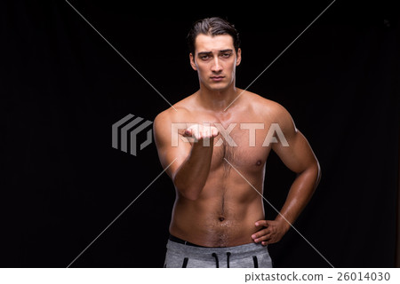 Ripped muscular man pressing virtual buttons 26014030